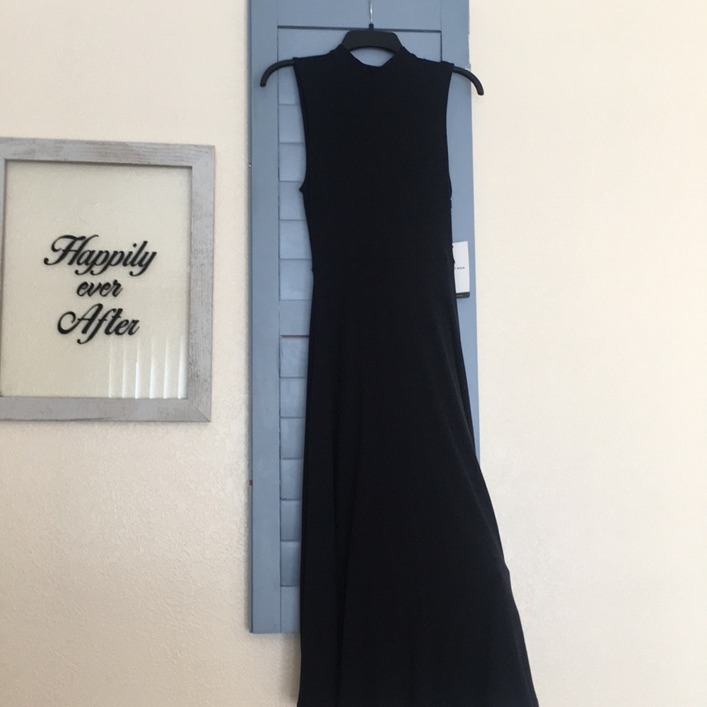 Adorable black midi dress with a scoop back.